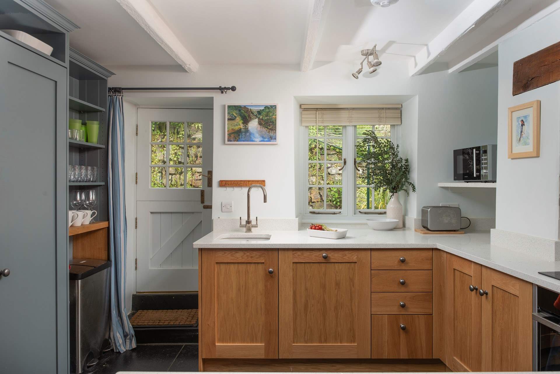 The back door leads out to a small patio which leads to the games-room and is perfect for drying wetsuits.