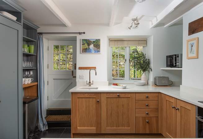 The back door leads out to a small patio which leads to the games-room and is perfect for drying wetsuits.