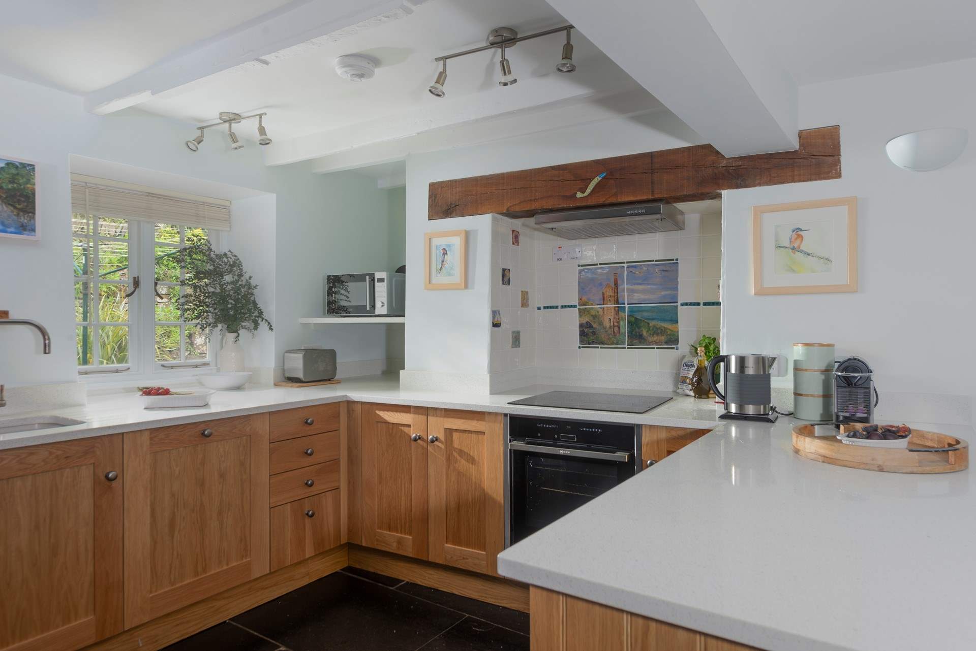The family kitchen is well-equipped and even has a coffee pod machine. 