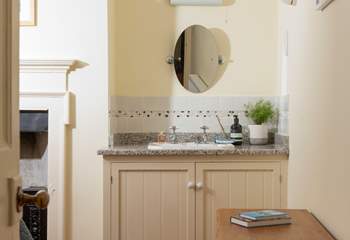 This bedroom has a handy wash-basin. 