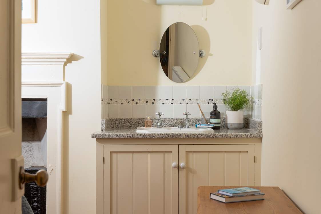 This bedroom has a handy wash-basin.