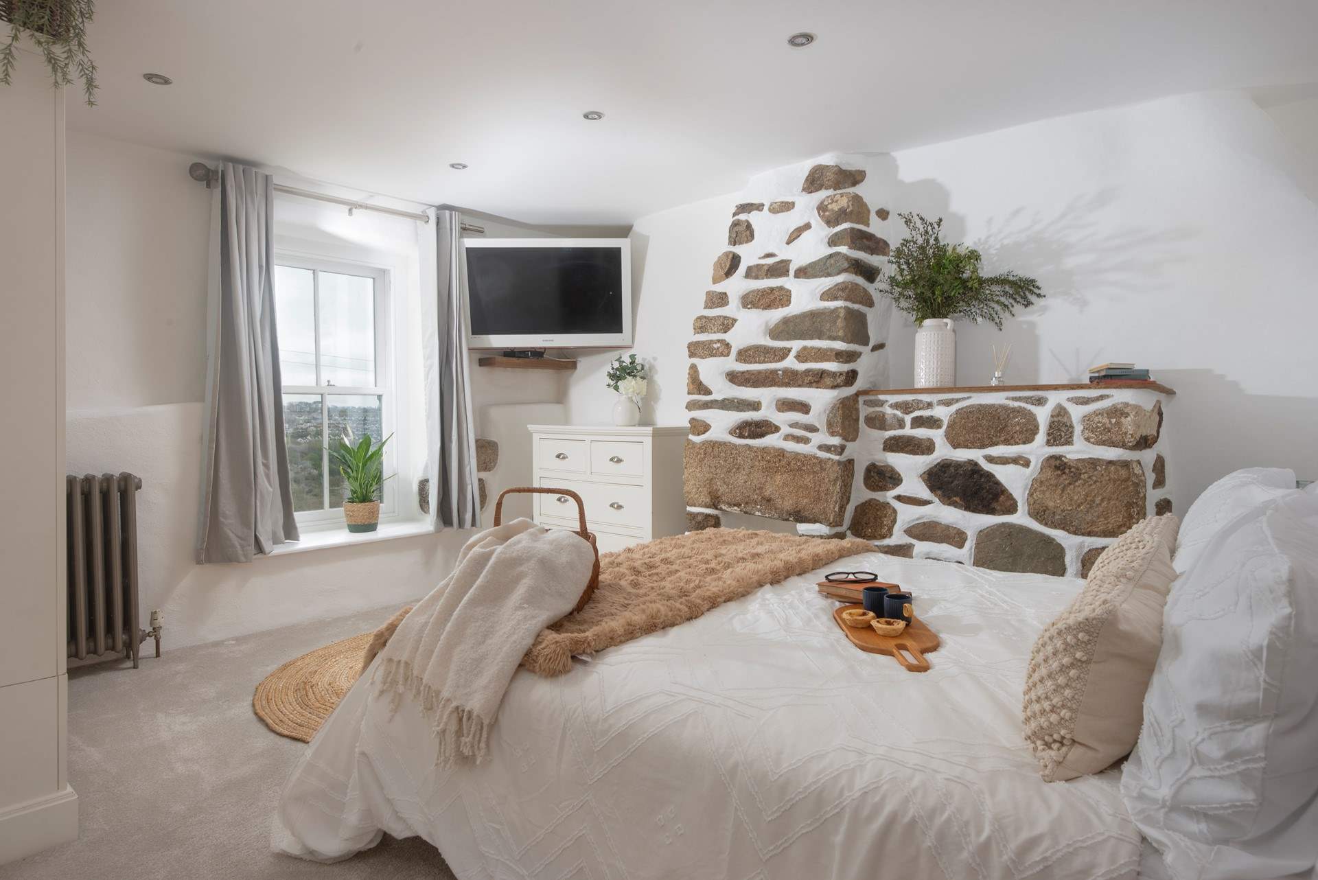 Bedroom 2 with a gorgeous feature stone chimney breast and valley views.