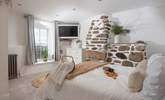 Bedroom 2 with a gorgeous feature stone chimney breast and valley views. - Thumbnail Image