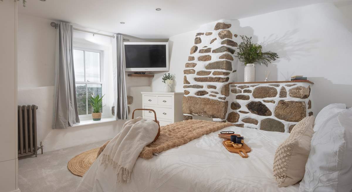 Bedroom 2 with a gorgeous feature stone chimney breast and valley views.