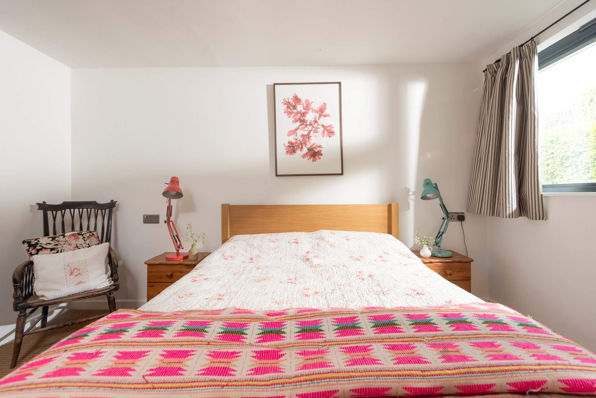 Brightly patterned linens dress the bed in the second bedroom.