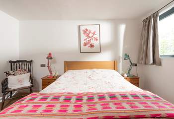 Brightly patterned linens dress the bed in the second bedroom.