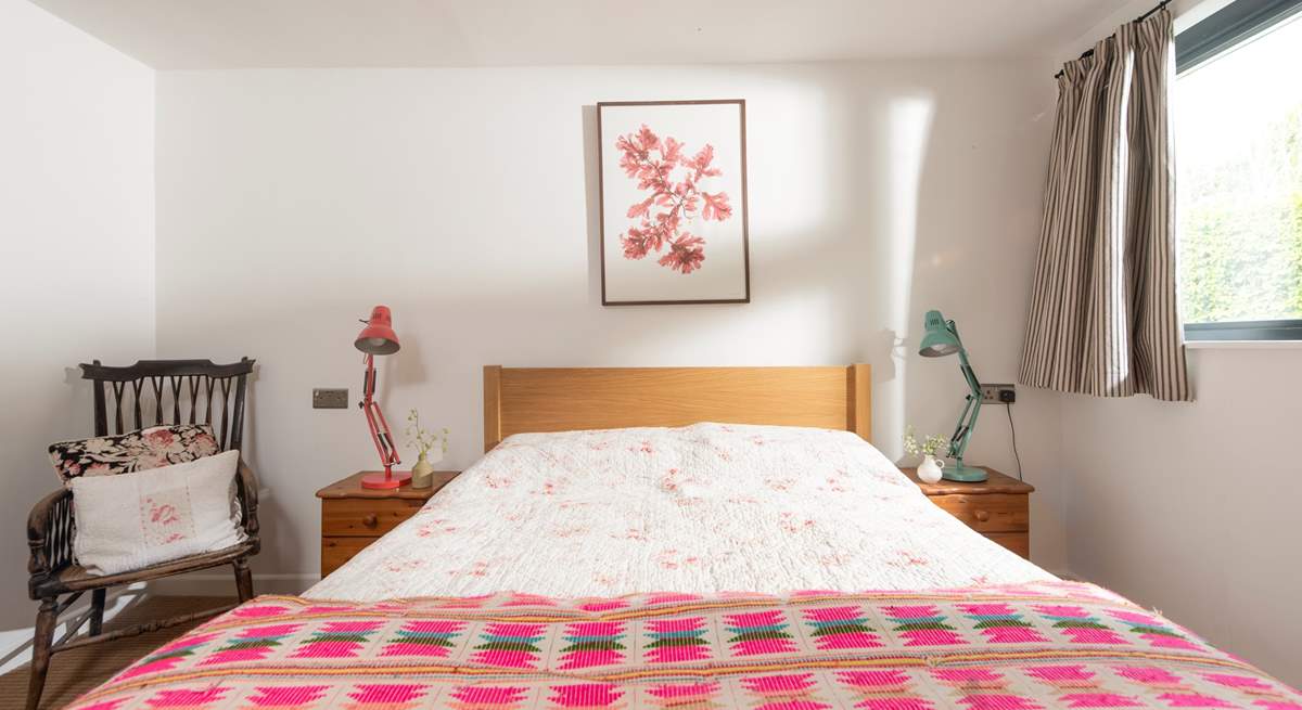 Brightly patterned linens dress the bed in the second bedroom.