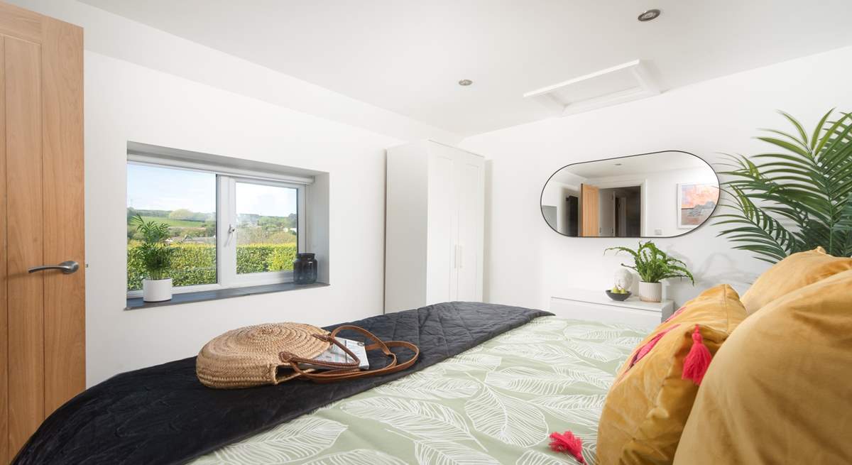 The principal bedroom has views out over the valley. 