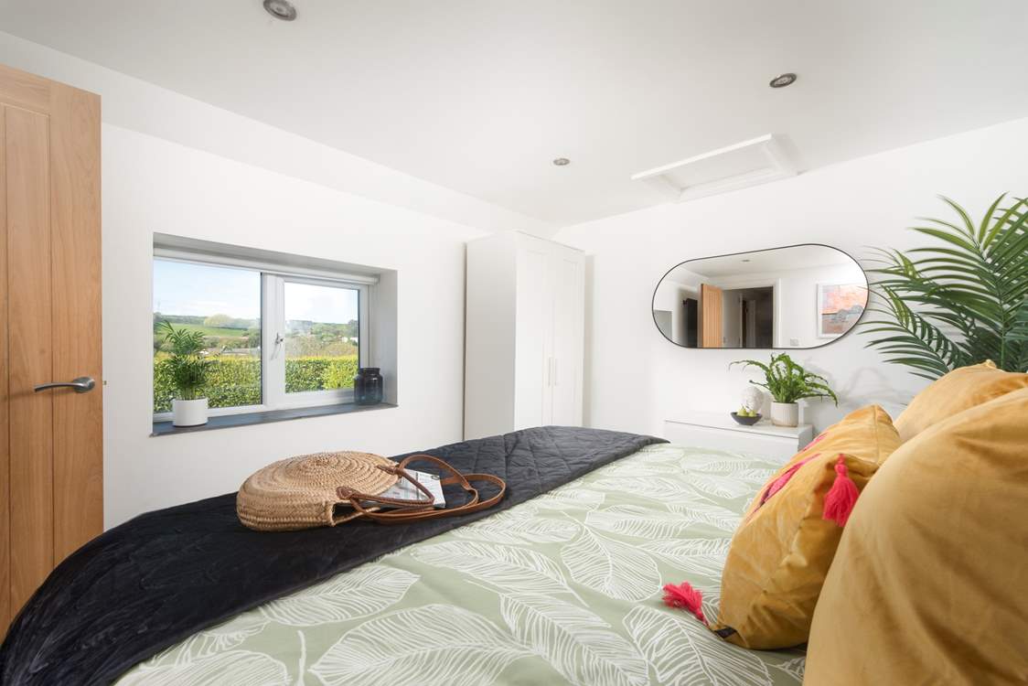 The principal bedroom has views out over the valley.