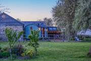 As dusk falls the setting becomes even more enchanting. (Please note the traditional buildings behind the hut are used for storage, they are not accommodation.)