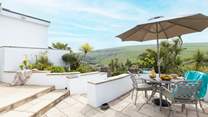 The immediate patio outside of the property offers the perfect brunch spot or all day relaxing haven with a gorgeous view out across the tropical garden.