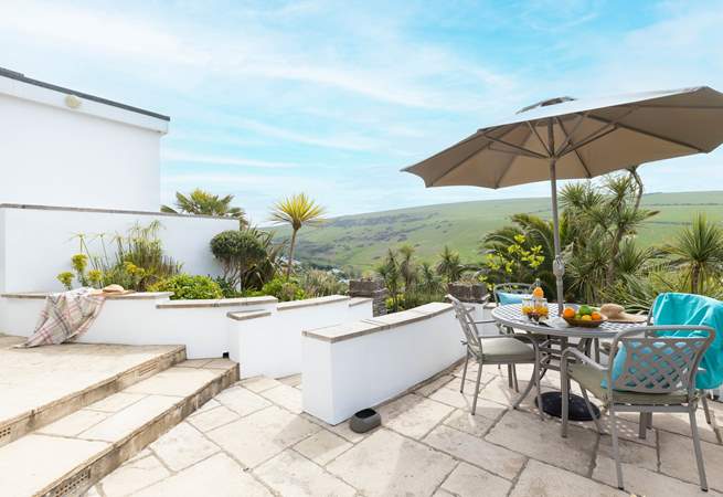 The immediate patio outside of the property offers the perfect brunch spot or all day relaxing haven with a gorgeous view out across the tropical garden.