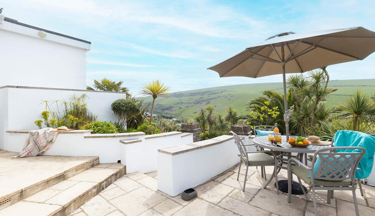 The immediate patio outside of the property offers the perfect brunch spot or all day relaxing haven with a gorgeous view out across the tropical garden.