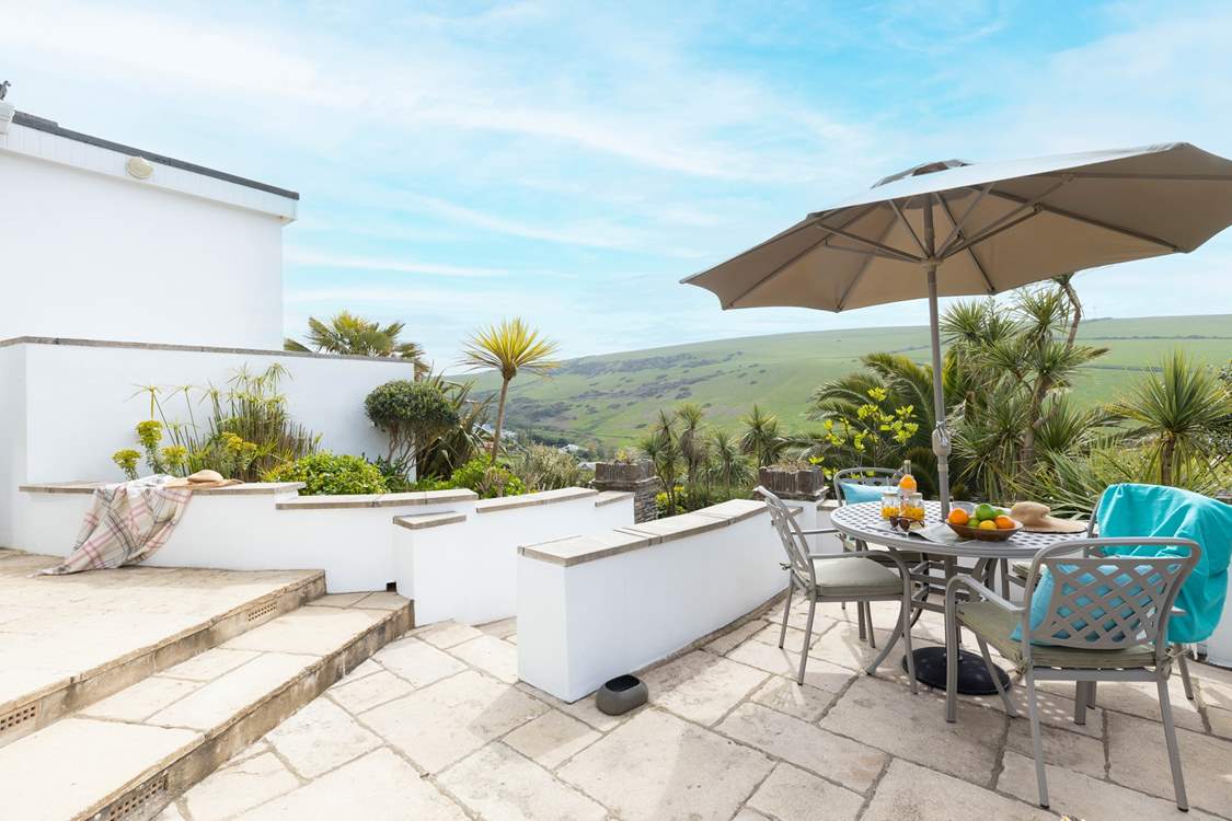 The immediate patio outside of the property offers the perfect brunch spot or all day relaxing haven with a gorgeous view out across the tropical garden.