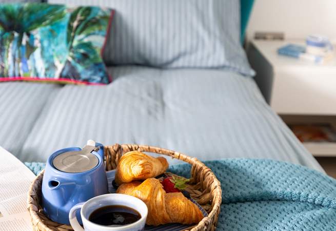A comfy bed awaits with fresh linens and gorgeous towels. 