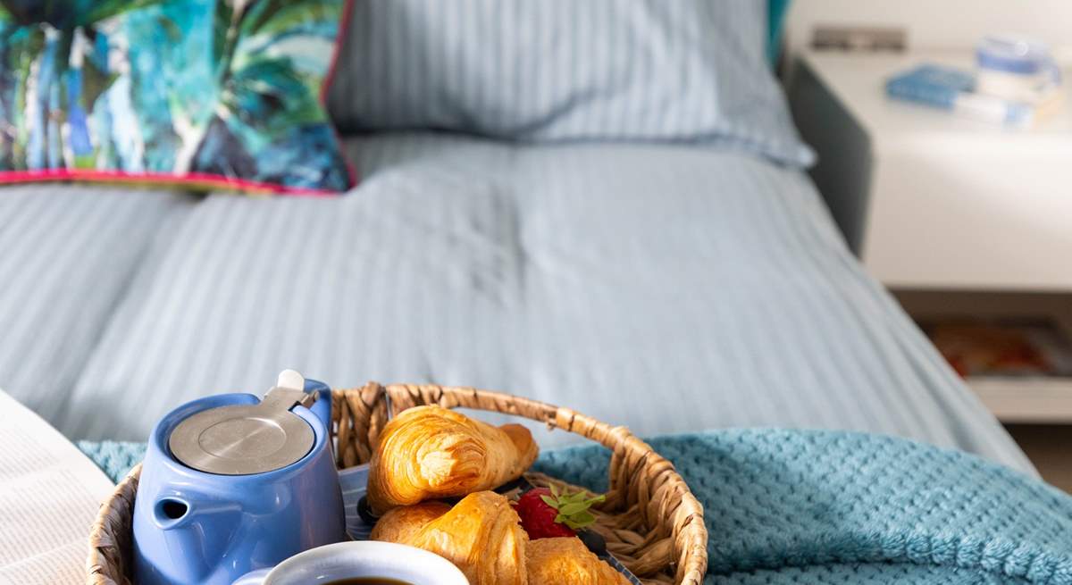 A comfy bed awaits with fresh linens and gorgeous towels. 