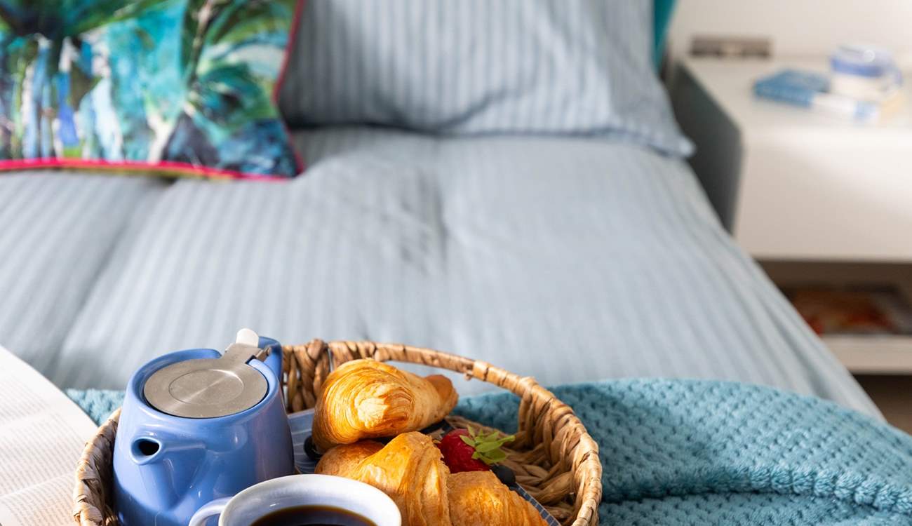 A comfy bed awaits with fresh linens and gorgeous towels. 