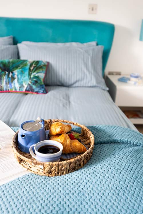 A comfy bed awaits with fresh linens and gorgeous towels.