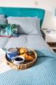 A comfy bed awaits with fresh linens and gorgeous towels.