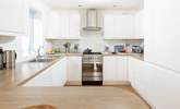 This fully equipped kitchen sits to the back of the open plan reception room. - Thumbnail Image