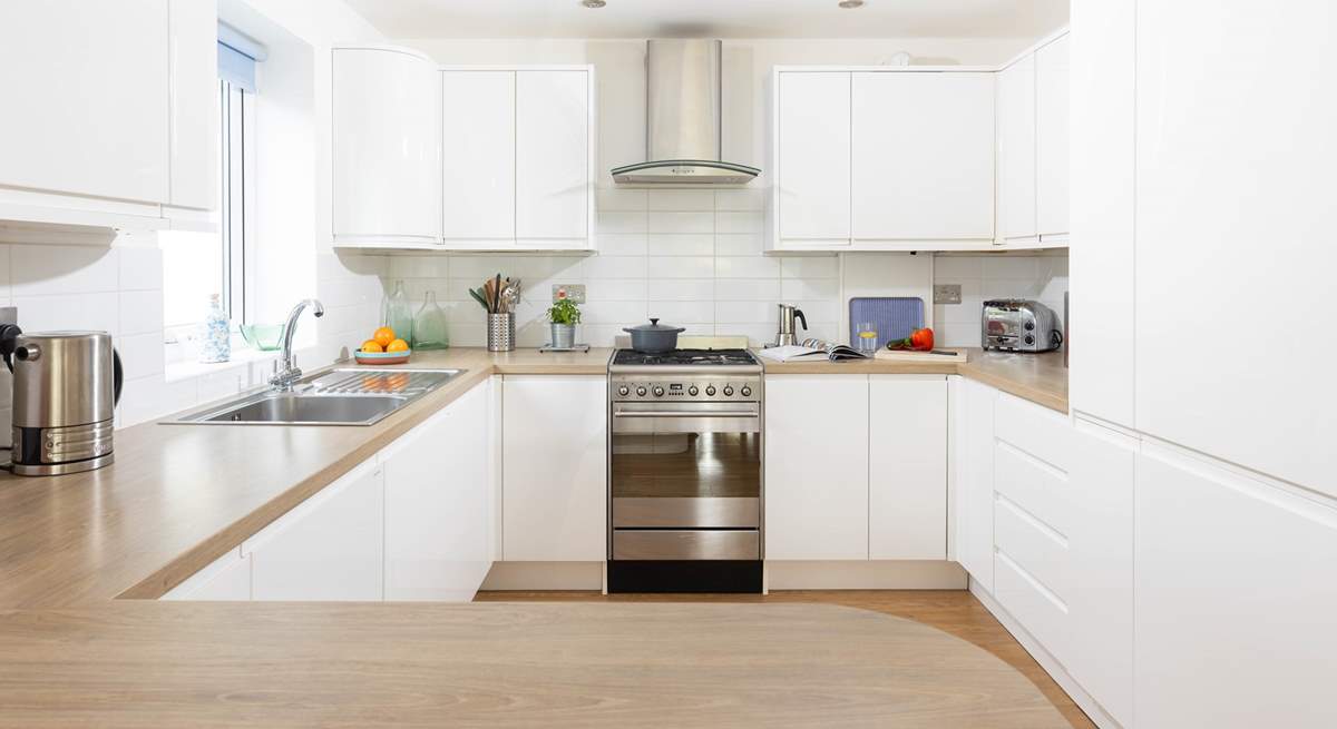 This fully equipped kitchen sits to the back of the open plan reception room.