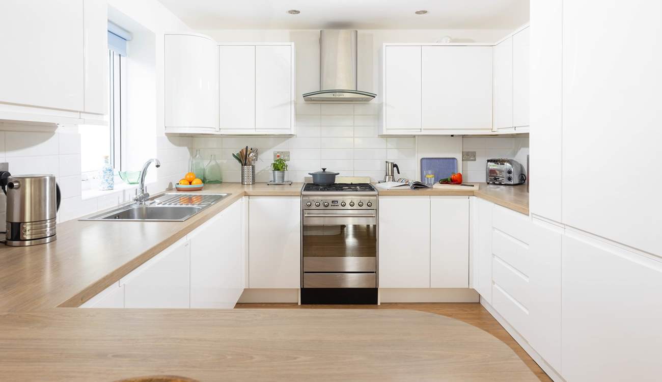 This fully equipped kitchen sits to the back of the open plan reception room.