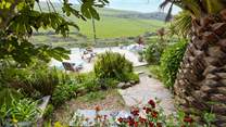 From the top patio, head down through the tropical garden to the lower terrace.