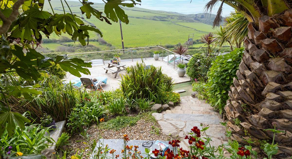 From the top patio, head down through the tropical garden to the lower terrace.