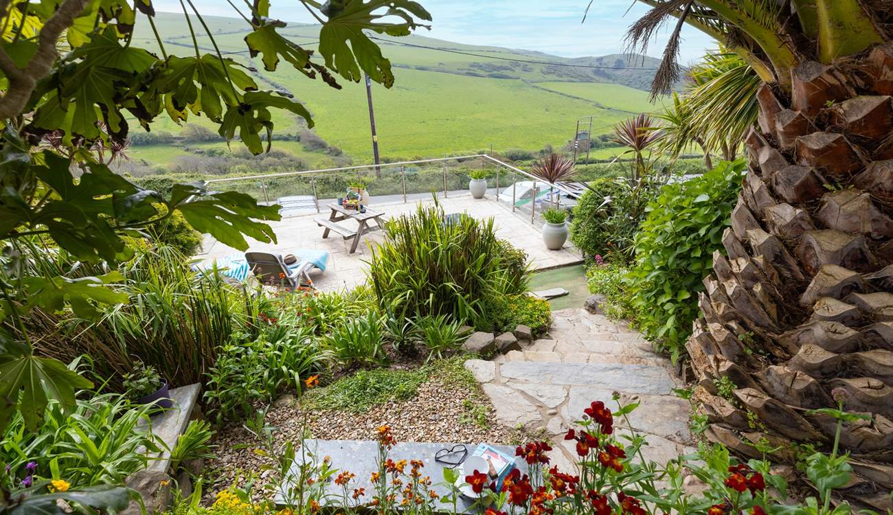 From the top patio, head down through the tropical garden to the lower terrace.