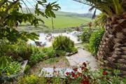 From the top patio, head down through the tropical garden to the lower terrace.