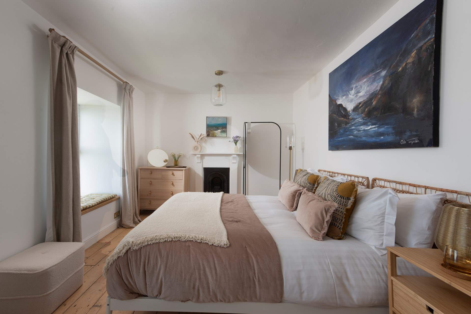 Bedroom 1 with ornate fireplace and more sea views.