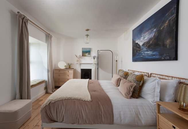 Bedroom 1 with ornate fireplace and more sea views.