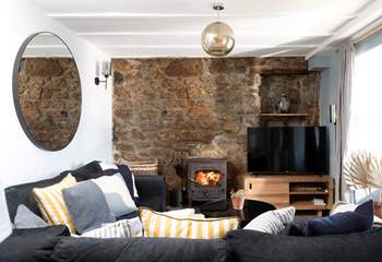 Snuggle up on the plush sofa warmed by the wood-burner on a chilly evening.