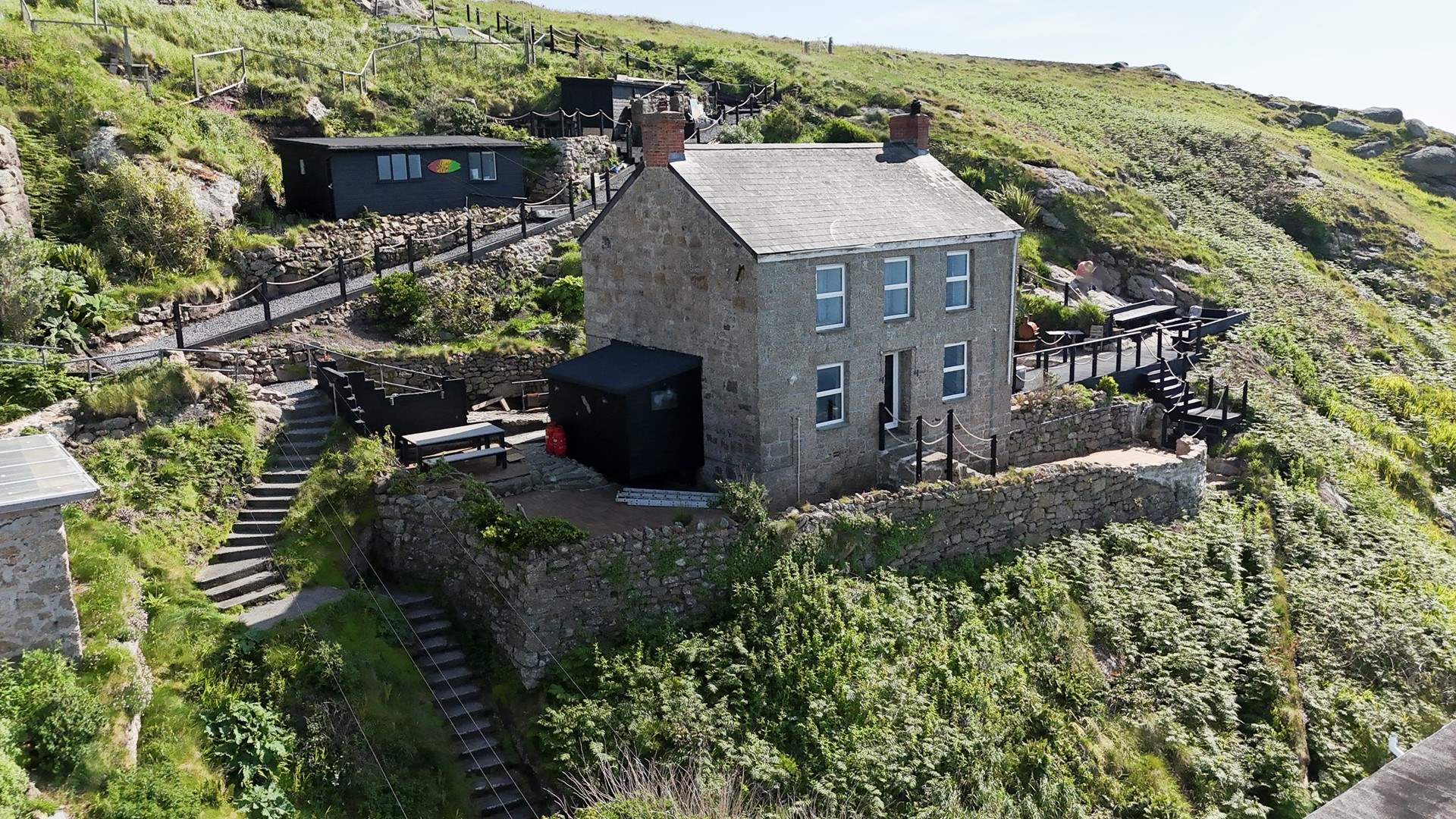 The parking for Peters Cottage is at the top of the winding steps behind the property.