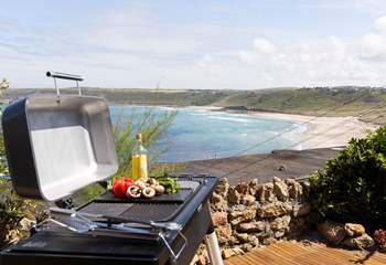 Enjoy dinner al fresco overlooking the sandy cove.
