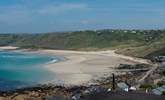 An impressive beach below, sandy shores and a bright blue sea. - Thumbnail Image