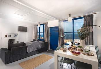 The views fill the open plan living area and there's a wood-burner too. 