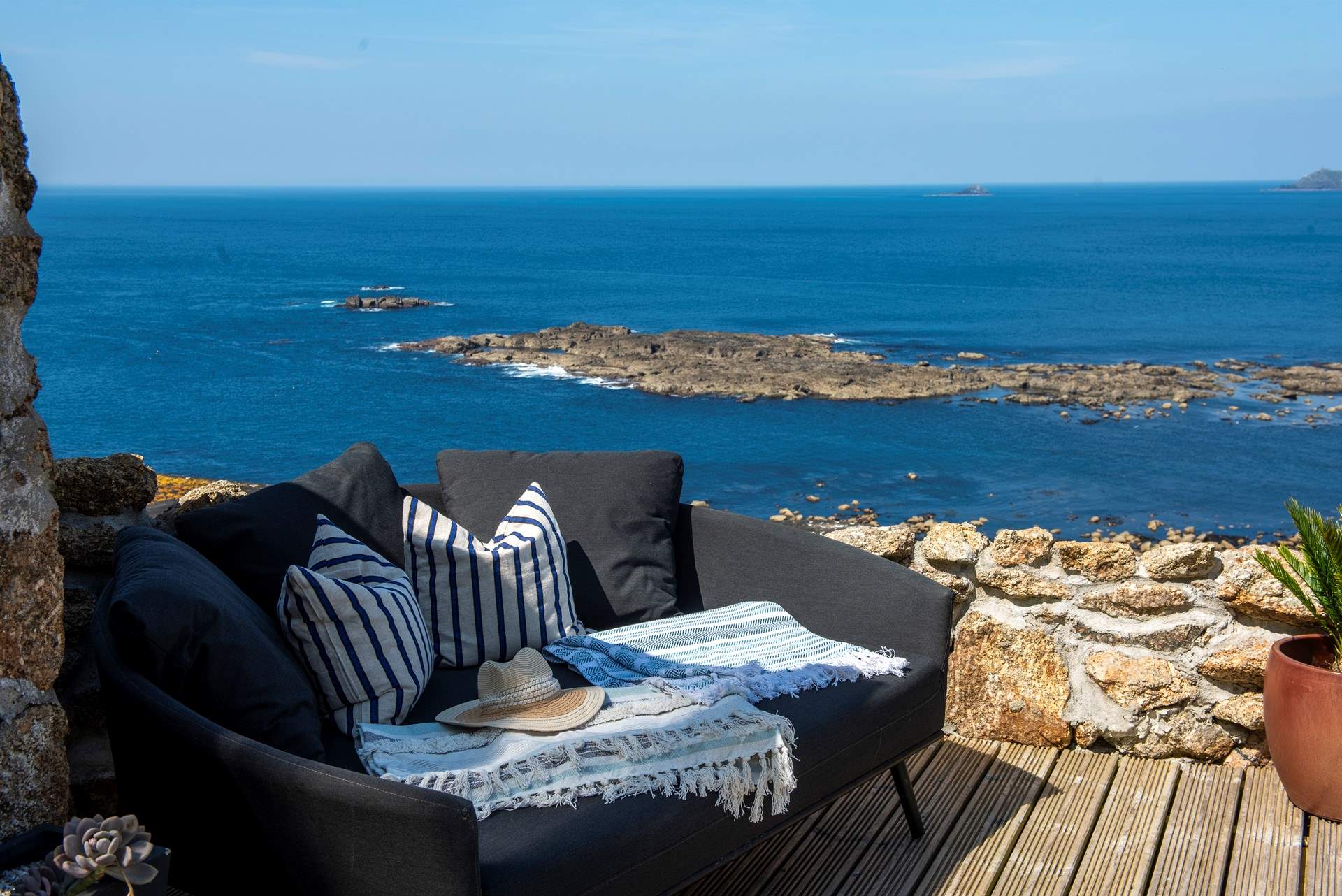 Take in the fresh sea air on the comfy outdoor sofa. 