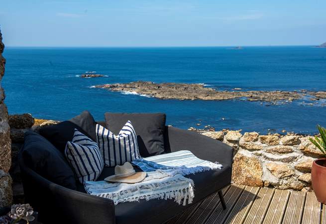 Take in the fresh sea air on the comfy outdoor sofa. 
