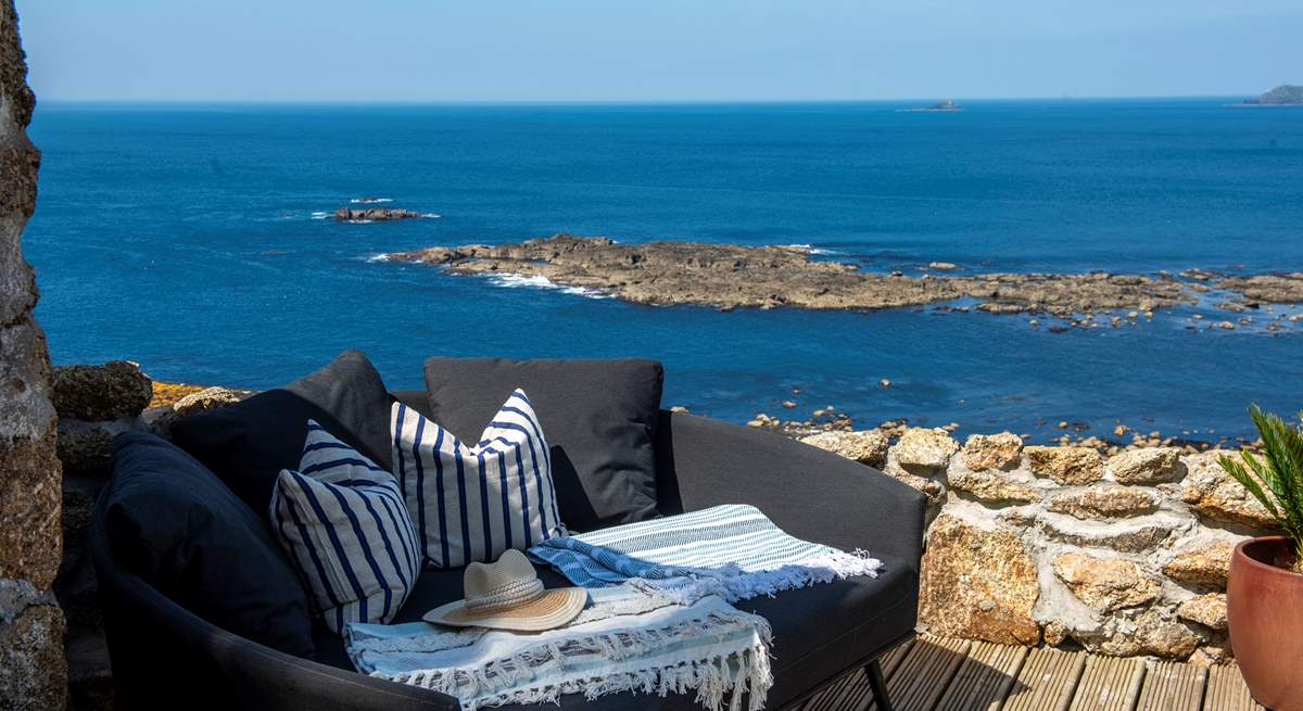 Take in the fresh sea air on the comfy outdoor sofa. 