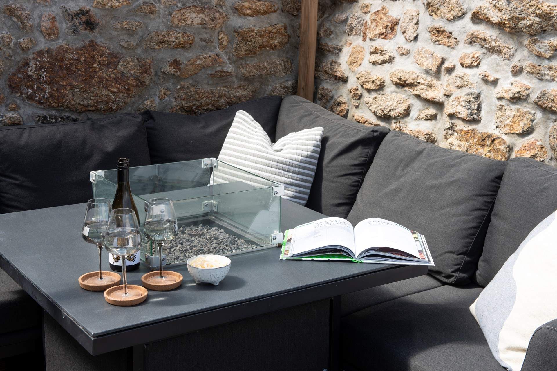 A second firepit is the centre piece of the covered outdoor dining area.