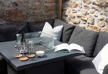 A second firepit is the centre piece of the covered outdoor dining area.