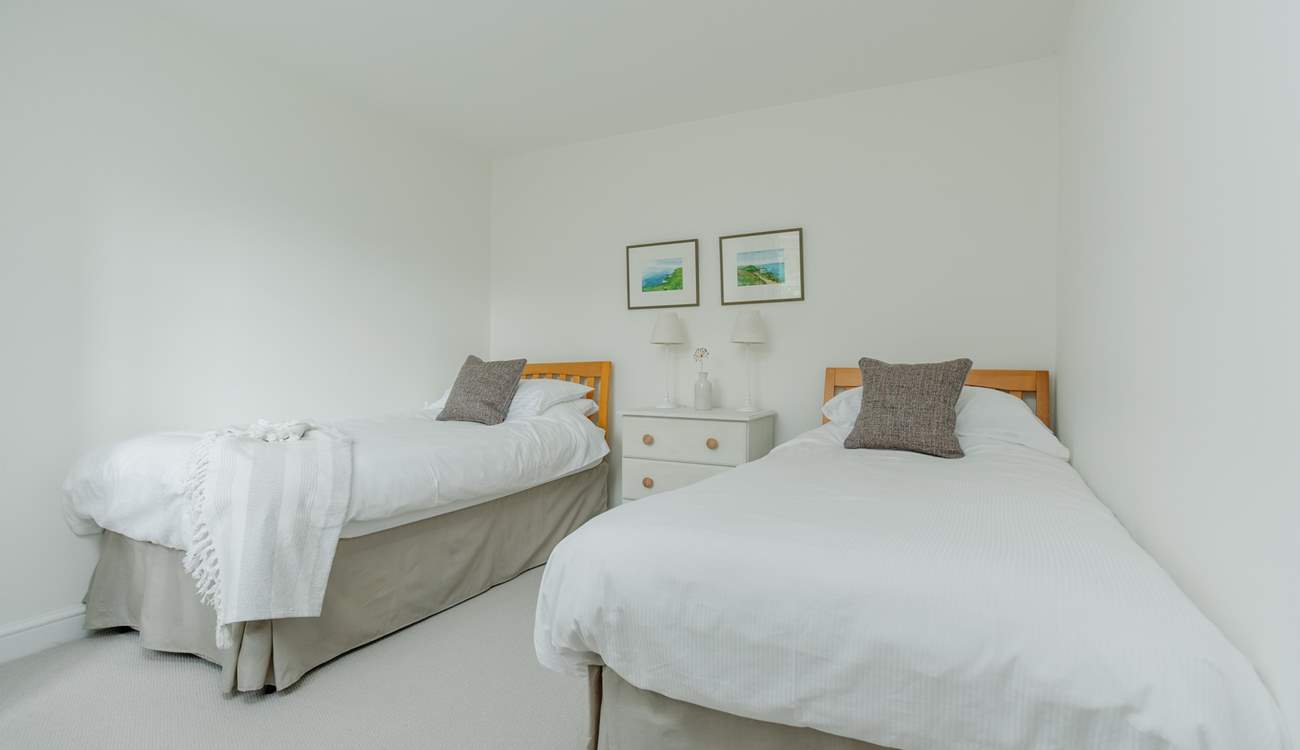 Relax in the pretty twin bedroom that has a separate wardrobe too.