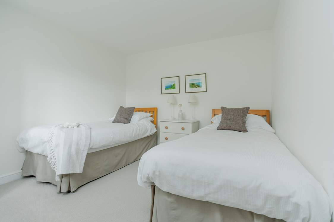 Relax in the pretty twin bedroom that has a separate wardrobe too.