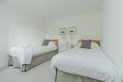 Relax in the pretty twin bedroom that has a separate wardrobe too.