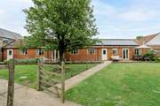 The Dairy is next door to The Granary and the gardens are separated by a wire fence. Privacy is ensured with the trellis just visible behind the tree.