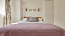 The primary bedroom (with en-suite shower room) has a tempting king size bed and plenty of storage. All complimented by the blissful peace and quiet of the countryside.
