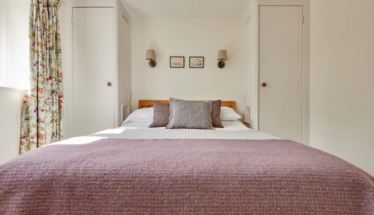 The primary bedroom (with en-suite shower room) has a tempting king size bed and plenty of storage. All complimented by the blissful peace and quiet of the countryside.