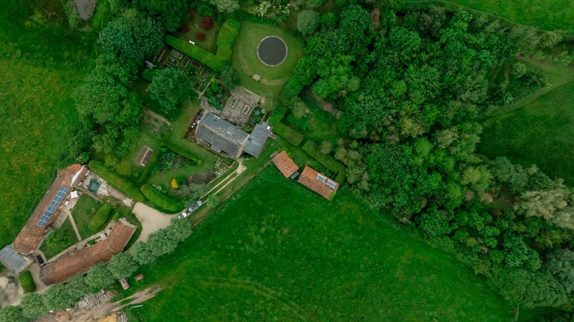 Looking from above - The Granary is the property next to the one with solar panels and the woodland is on the right hand side of the photo, beyond the owners' home.