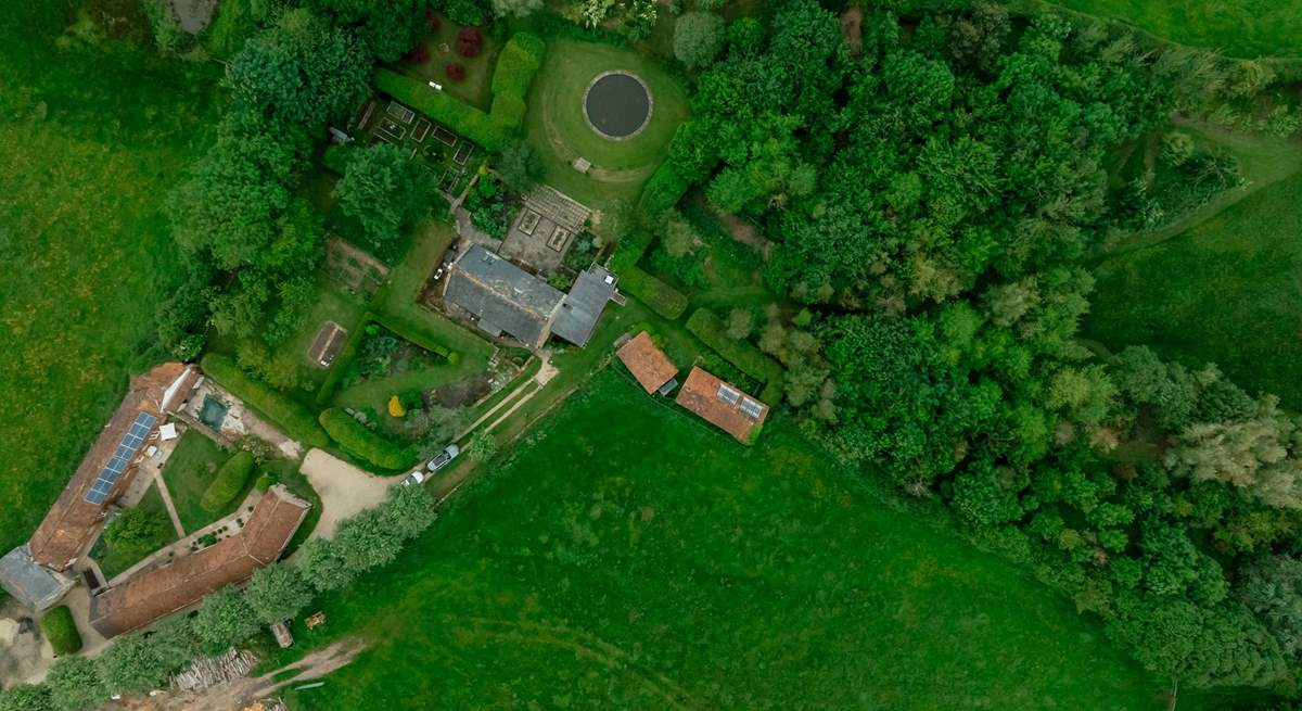 Looking from above - The Granary is the property next to the one with solar panels and the woodland is on the right hand side of the photo, beyond the owners' home.